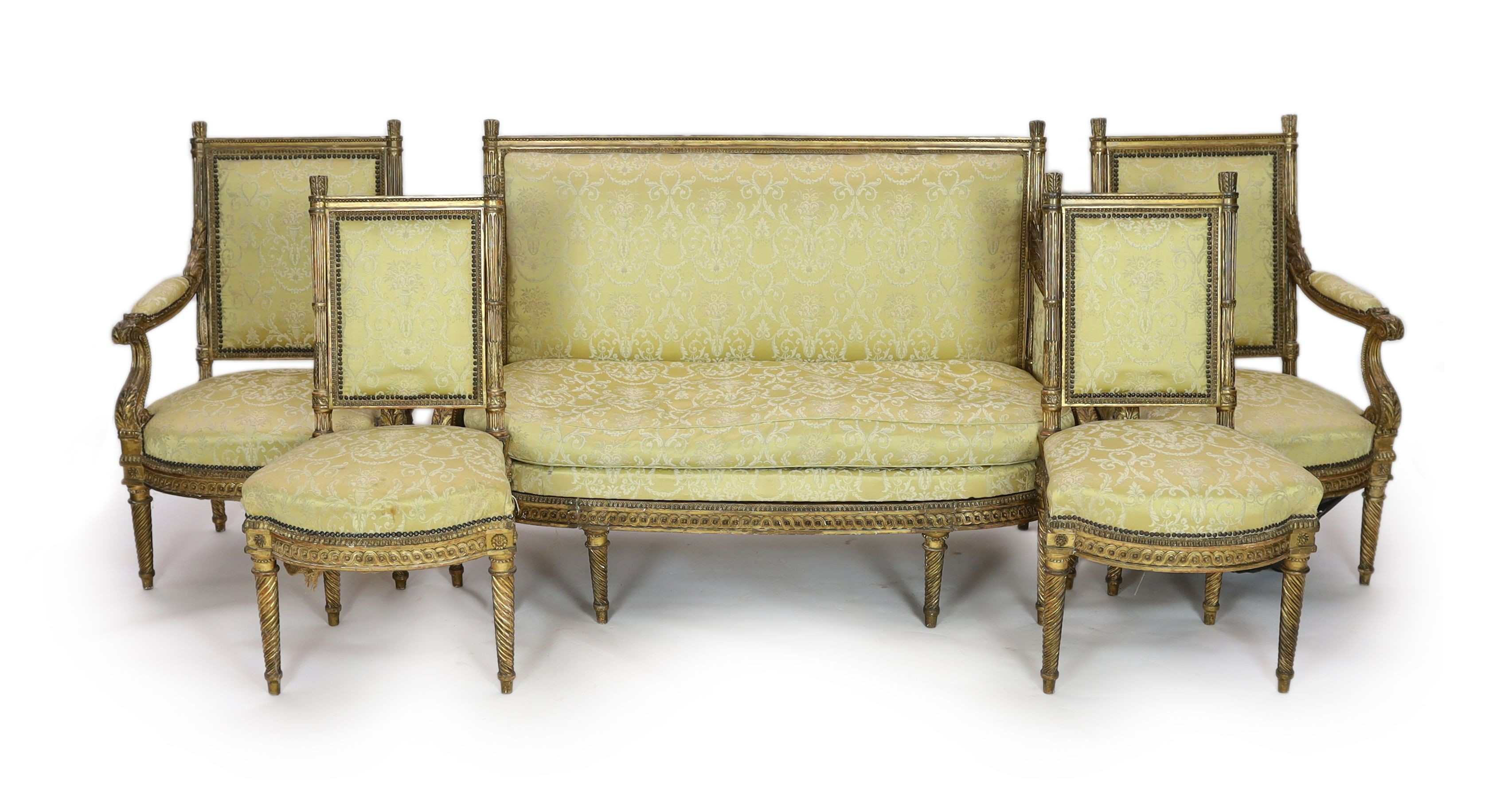 A Louis XVI carved giltwood five piece salon suite, settee W.148cm D.69cm H.100cm